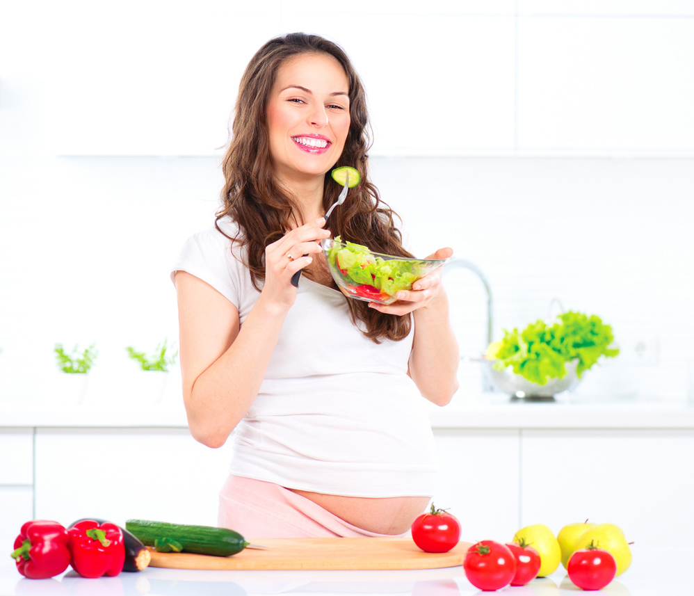 Pregnant Woman Eating Vegetable Salad. Cooking Vegetables